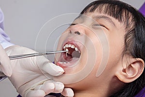 Asian Chinese little girl lying down for tooth extraction