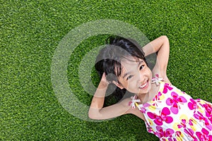 Asian Chinese little girl lying on the grass