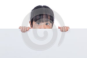 Asian Chinese little girl peeping behind white board