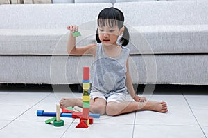 Asian Chinese little girl playing blocks on the floor