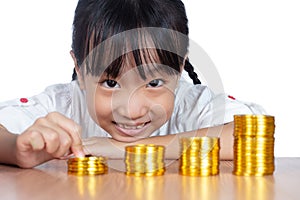 Asian Chinese little girl playing with golden Bitcoin