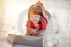 Asian Chinese little girl playing laptop