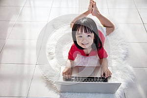 Asian Chinese little girl playing laptop