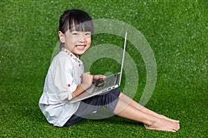 Asian Chinese little girl playing with laptop