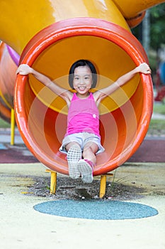 Asian Chinese little girl playing at outdoor playground