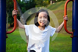 Asian Chinese little girl playing at outdoor playground