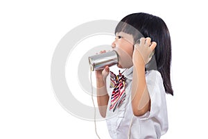 Asian Chinese little girl playing retro tin can phone