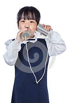 Asian Chinese little girl playing retro tin can phone