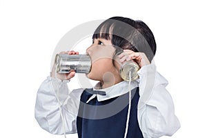 Asian Chinese little girl playing retro tin can phone