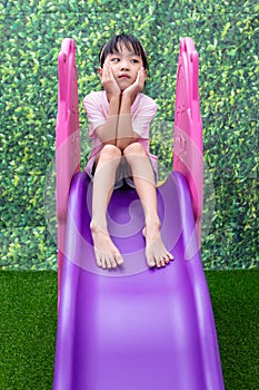 Asian Chinese Little Girl Playing on the slide