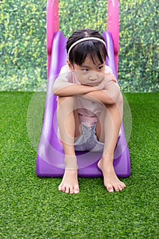 Asian Chinese Little Girl Playing on the slide