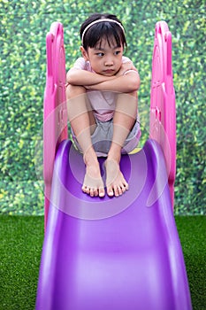 Asian Chinese Little Girl Playing on the slide