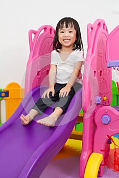 Asian Chinese little girl playing on the slide