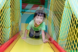 Asian Chinese little girl playing slide