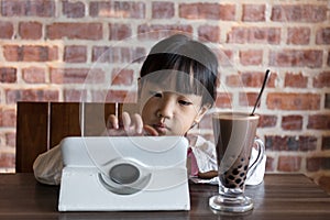 Asian Chinese little girl playing tablet computer
