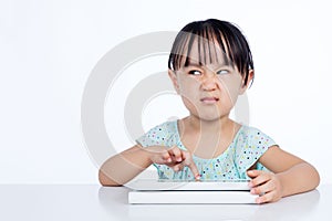 Asian Chinese little girl playing with tablet computer