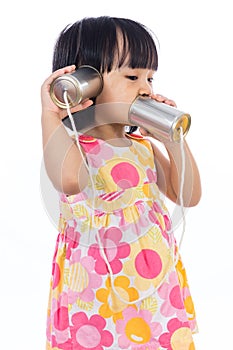 Asian Chinese little girl playing tin can phone
