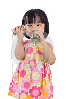 Asian Chinese little girl playing tin can phone