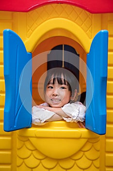 Asian Chinese little girl playing in toy house