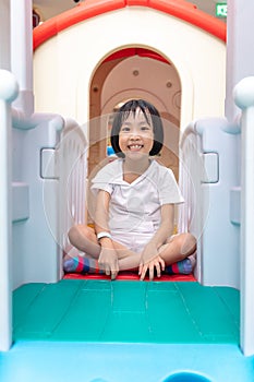 Asian Chinese little girl playing in toy house