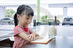 Asian Chinese little girl reading book