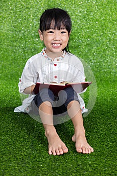 Asian Chinese little girl reading a book