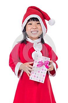 Asian Chinese little girl in santa costume holding gift box