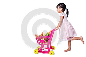 Asian Chinese little girl with shopping trolley full of vegetables