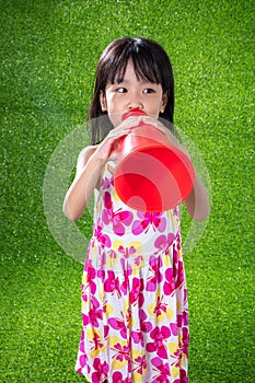 Asian Chinese little girl shouting through megaphone