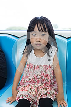 Asian Chinese little girl sitting inside a MRT transit