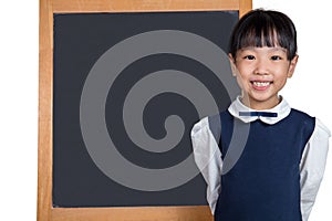 Asian Chinese little girl standing in front of blackboard