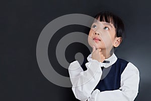 Asian Chinese little girl standing in front of blackboard