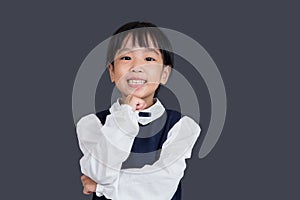 Asian Chinese little girl standing in front of blackboard