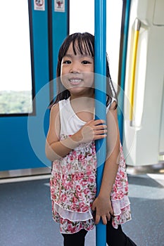 Asian Chinese little girl standing inside a MRT transit