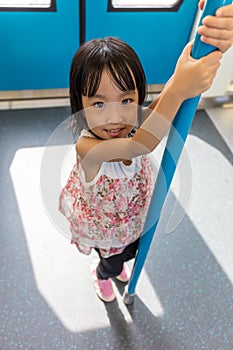 Asian Chinese little girl standing inside a MRT transit