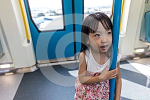 Asian Chinese little girl standing inside a MRT transit