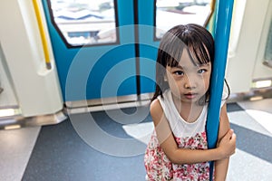 Asian Chinese little girl standing inside a MRT transit