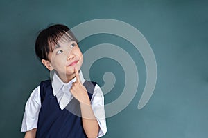 Asian Chinese little Girl thinking with finger on chin