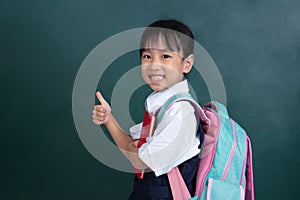 Asian Chinese little Girl in uniform showing thumbs up against g