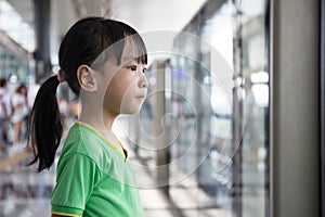 Asian Chinese little girl waiting for transit