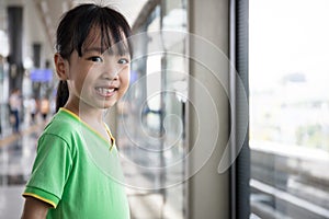 Asian Chinese little girl waiting for transit
