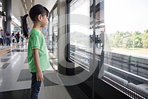 Asian Chinese little girl waiting for transit