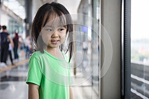 Asian Chinese little girl waiting for transit