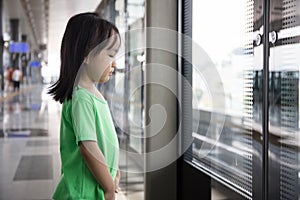 Asian Chinese little girl waiting for transit