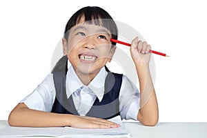 Asian Chinese little girl wearing school uniform studying