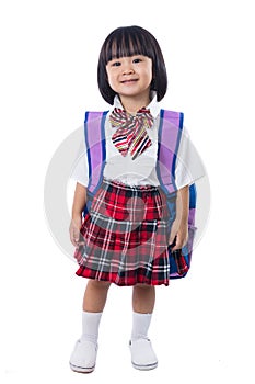 Asian Chinese little girl wearing student uniform and school bag