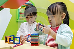 Asian Chinese little girls playing colorful magnet plastic block