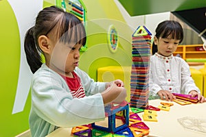 Asian Chinese little girls playing colorful magnet plastic block