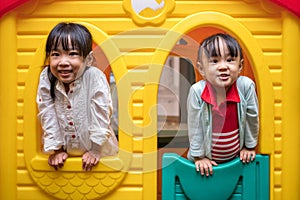 Asian Chinese little girls playing in toy house