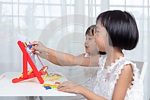 Asian Chinese little girls playing toys